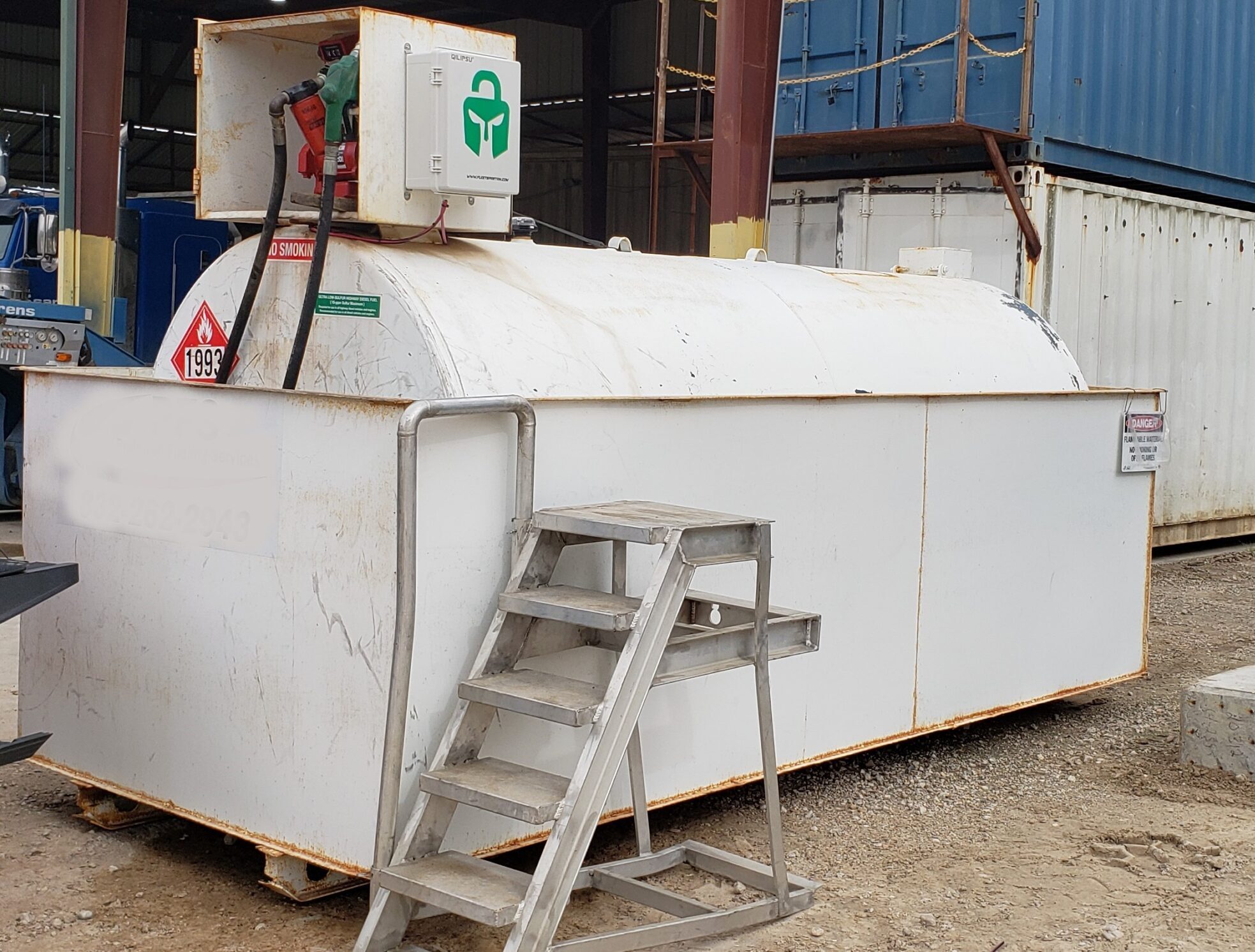 Fuel storage tank with metal stairs outside.
